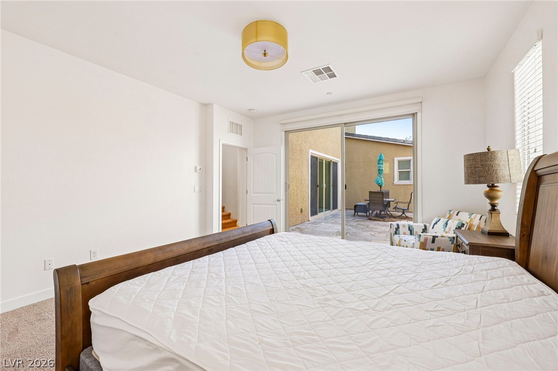 1100 East Sunset Road Henderson, NV 89011 - Photo 24 of 63 Sliding glass doors open directly from the bedroom onto a sunny backyard patio.