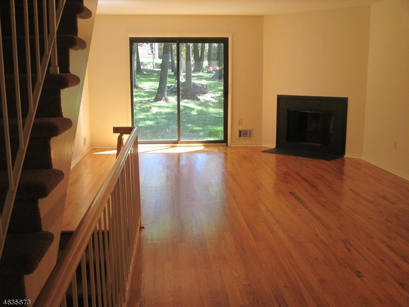 181 Long Hill Road, Unit K1 Little Falls, NJ 07424 - Photo 2 of 11 a view of an empty room with wooden floor and a window