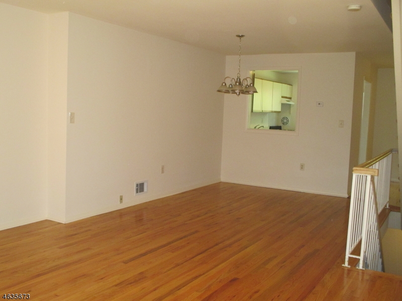 181 Long Hill Road, Unit K1 Little Falls, NJ 07424 - Photo 3 of 11 a view of empty room with wooden floor