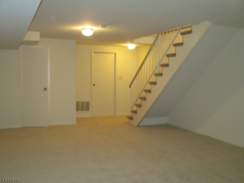 181 Long Hill Road, Unit K1 Little Falls, NJ 07424 - Photo 7 of 11 a view of an empty room with stairs