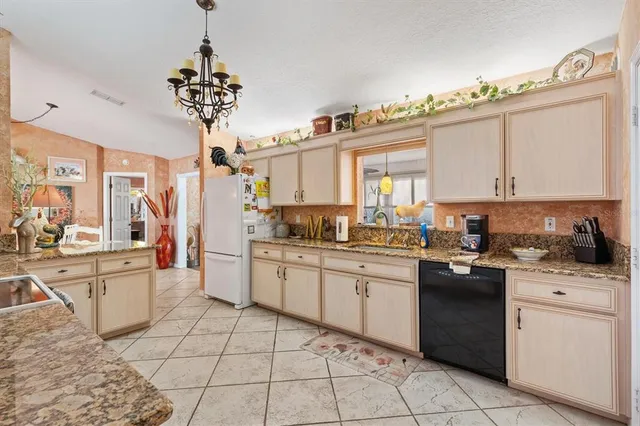 a bed room with a bed and a chandelier