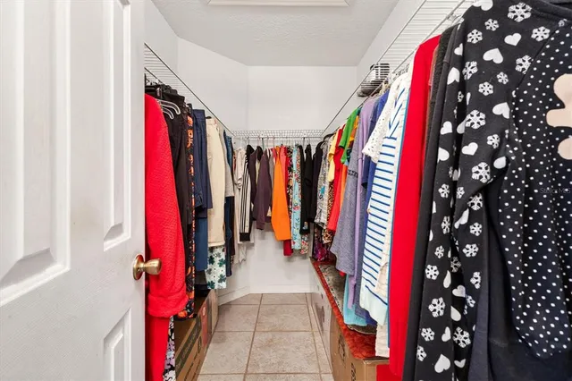 a bedroom with a bed and ceiling fan