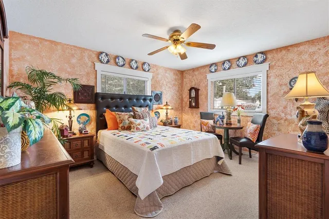 a bathroom with a granite countertop sink a large mirror and a shower