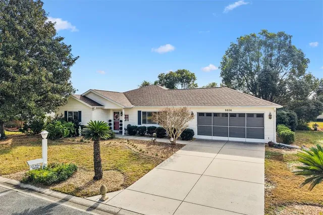 a front view of house with yard and trees