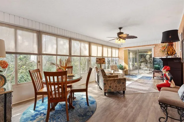 a living room with furniture a flat screen tv and a window