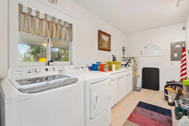 a living room with furniture a chandelier and a large window