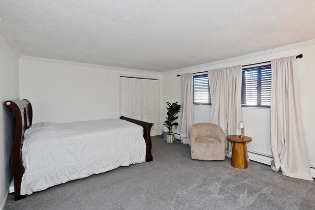 a bedroom with bed and a window