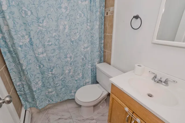 a white toilet sitting next to a bathroom sink
