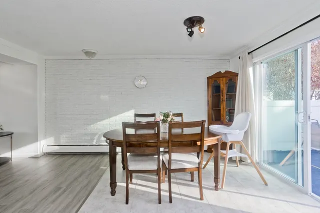 a dining room with furniture and wooden floor