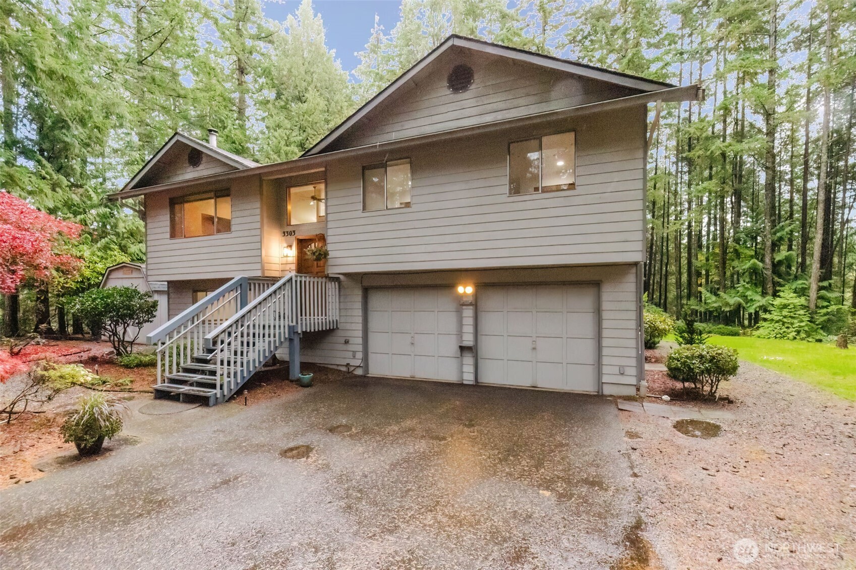 3303 Northwest Half Mile Road Silverdale, WA 98383 - Photo 2 of 33 a front view of a house with a yard and garage