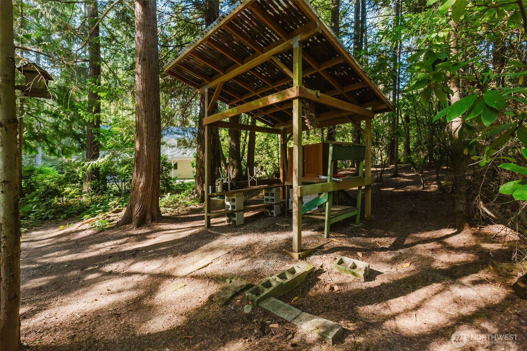 3303 Northwest Half Mile Road Silverdale, WA 98383 - Photo 31 of 33 a view of a patio with table and chairs under an umbrella