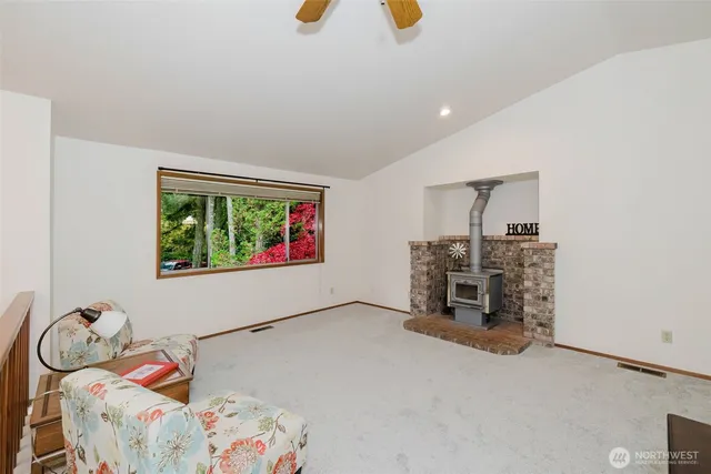 a dining room with furniture a chandelier and wooden floor