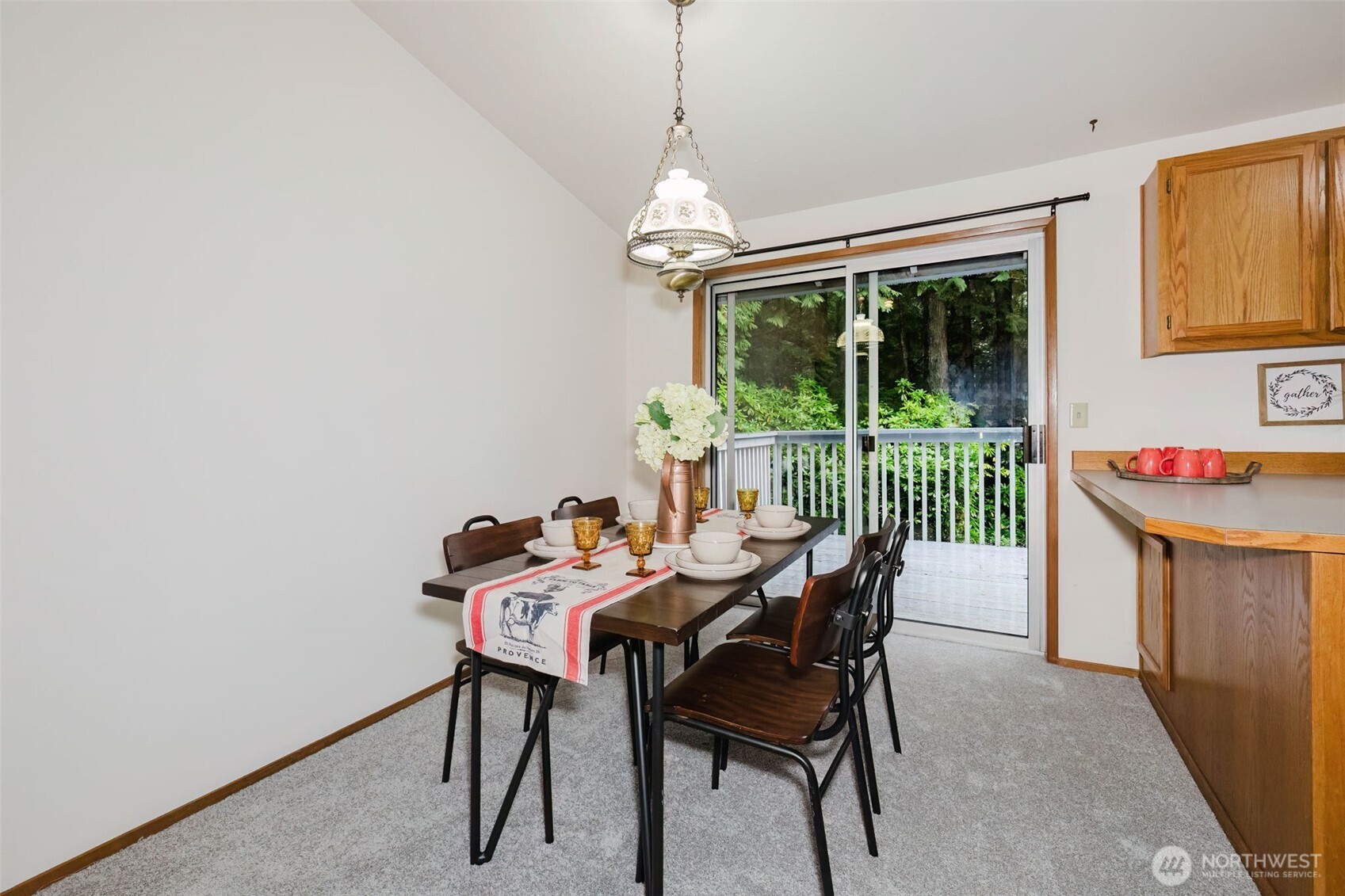 3303 Northwest Half Mile Road Silverdale, WA 98383 - Photo 5 of 33 a dining room with furniture a chandelier and wooden floor