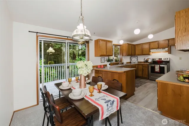 a kitchen with stainless steel appliances granite countertop a sink stove and wooden cabinets
