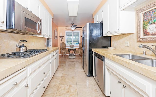 a kitchen with a sink stove and refrigerator