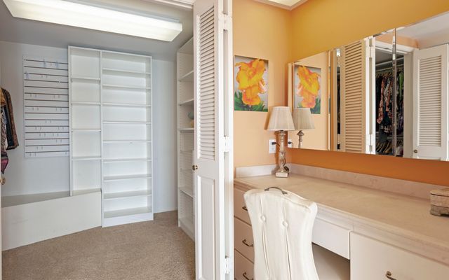 a view of a bedroom with furniture and windows