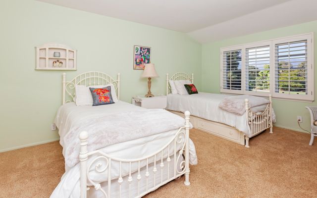 a spacious bedroom with a bed and a table in it