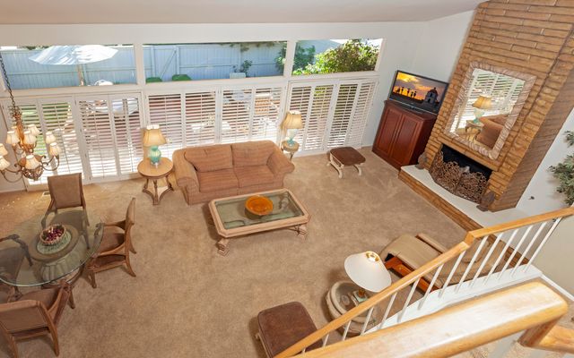 a balcony with furniture and wooden floor
