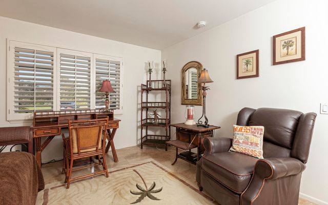 a work room with furniture and large windows