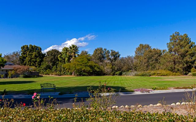 a backyard of a house with a yard and outdoor seating