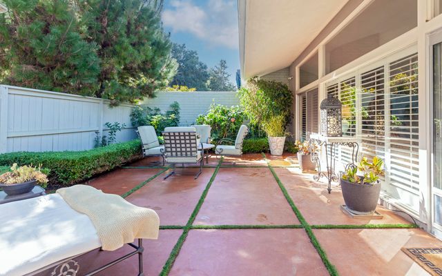 a view of a backyard with sitting area