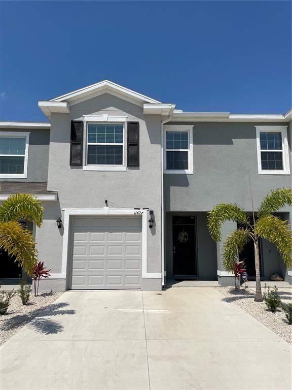 11427 Planetree Place Bradenton, FL 34211 - Photo 1 of 28 a front view of a house with a yard and garage