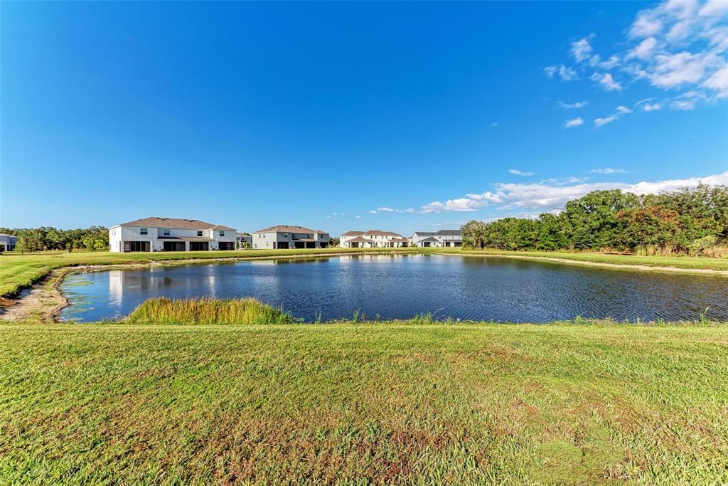 11427 Planetree Place Bradenton, FL 34211 - Photo 14 of 28 a view of a lake with houses in the background