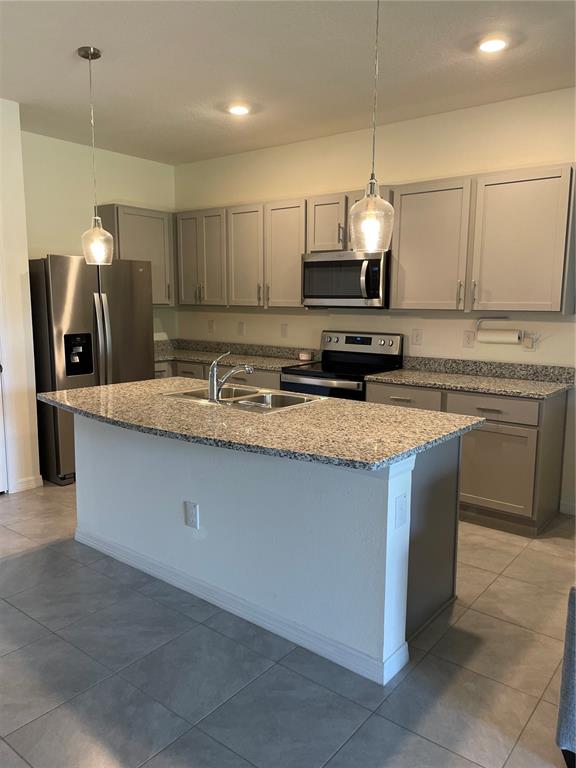11427 Planetree Place Bradenton, FL 34211 - Photo 2 of 28 a kitchen with stainless steel appliances granite countertop a sink a stove and a refrigerator