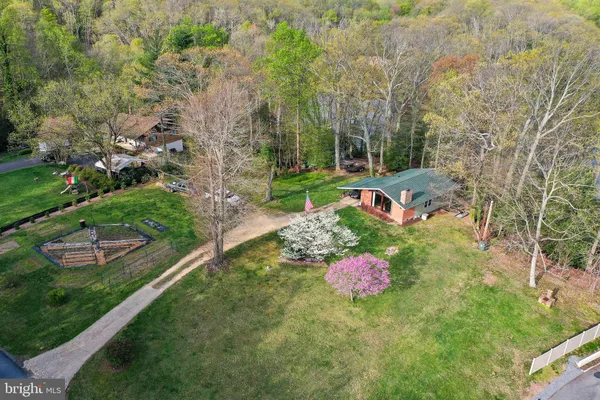 a front view of a house with a yard and lake