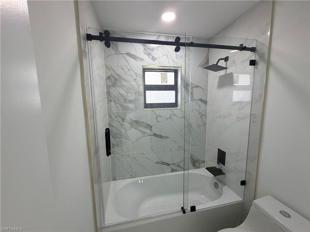 15 Louisiana Road Lehigh Acres, FL 33936 - Photo 4 of 22 a bathroom with a shower and a bathtub
