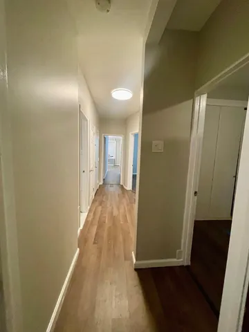 a view of hallway with wooden floor