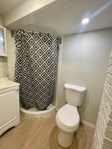 a white toilet sitting next to a bathroom sink
