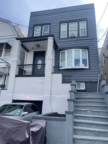 a front view of a house with stairs