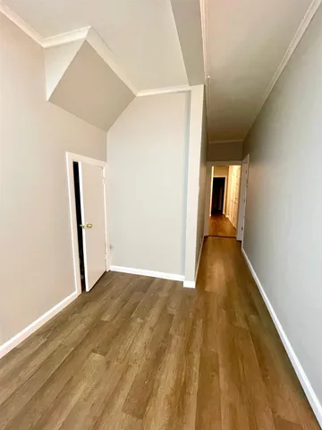 a view of a hallway with wooden floor