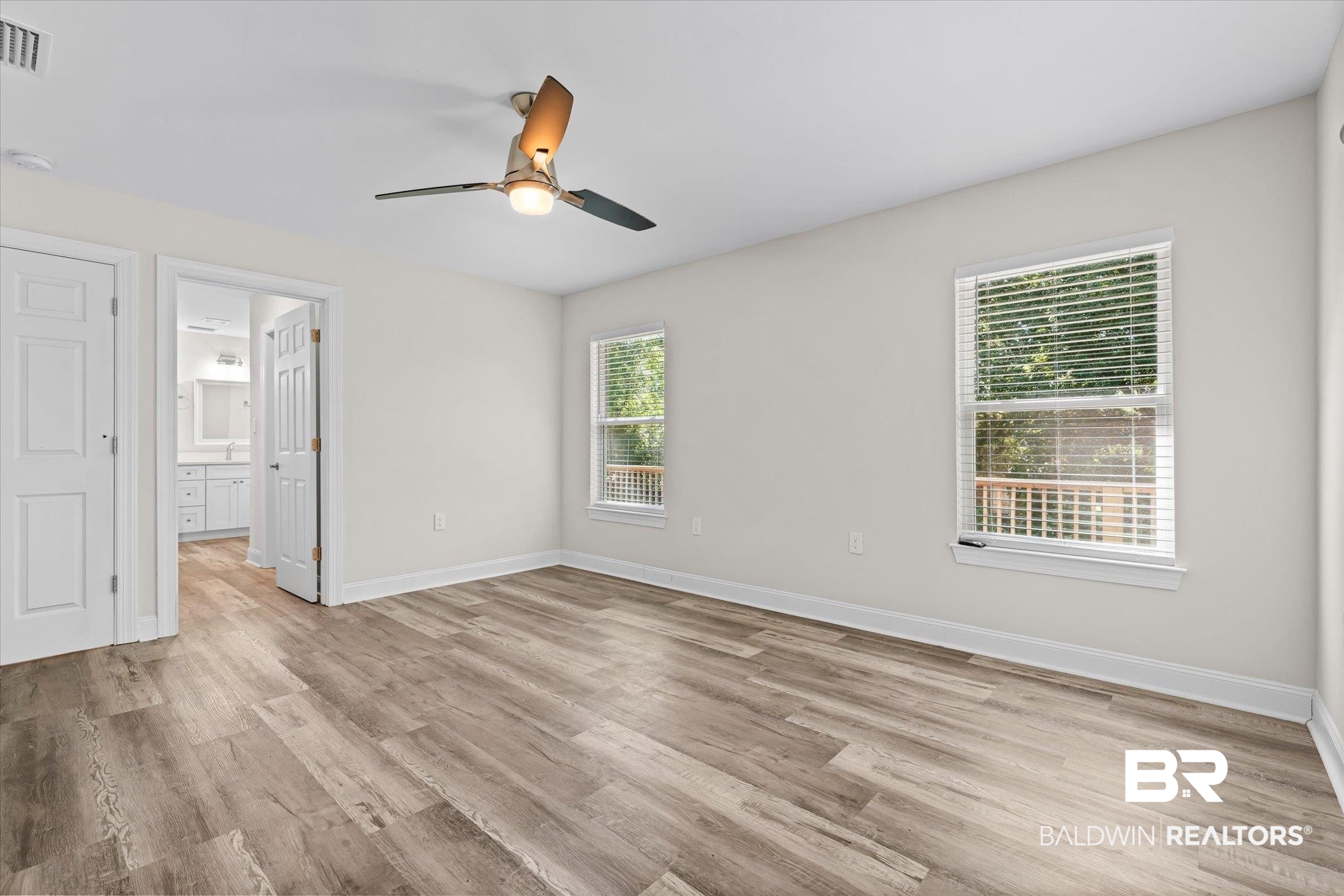 113 Pineridge Road Daphne, AL 36526 - Photo 9 of 22 Unfurnished room featuring ceiling fan, light wood-type flooring, and a wealth of natural light