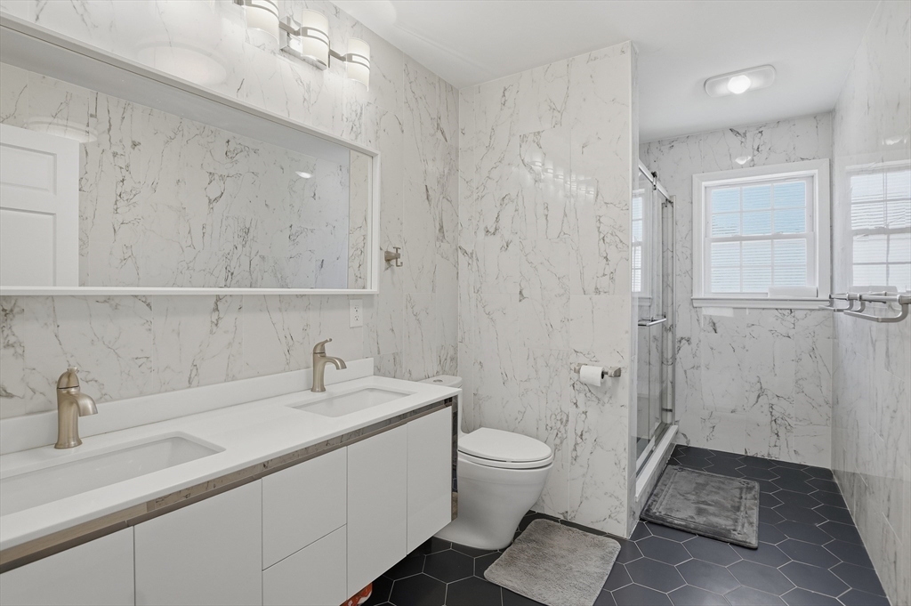 112 Pineland Avenue Worcester, MA 01604 - Photo 16 of 38 a bathroom with a double vanity sink mirror and toilet