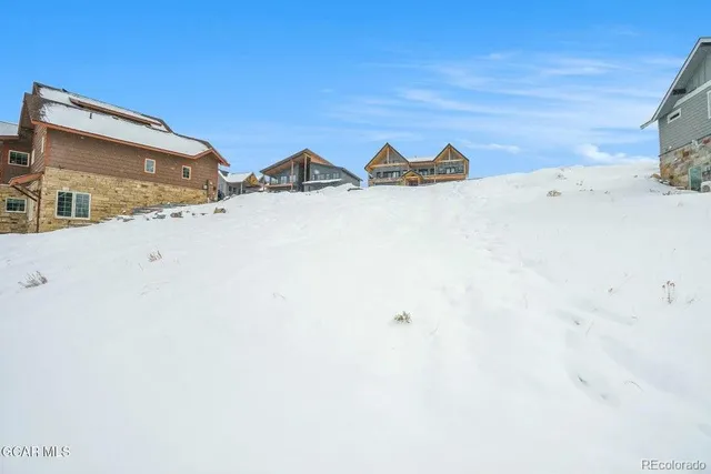 a view of a house with a snow on the road