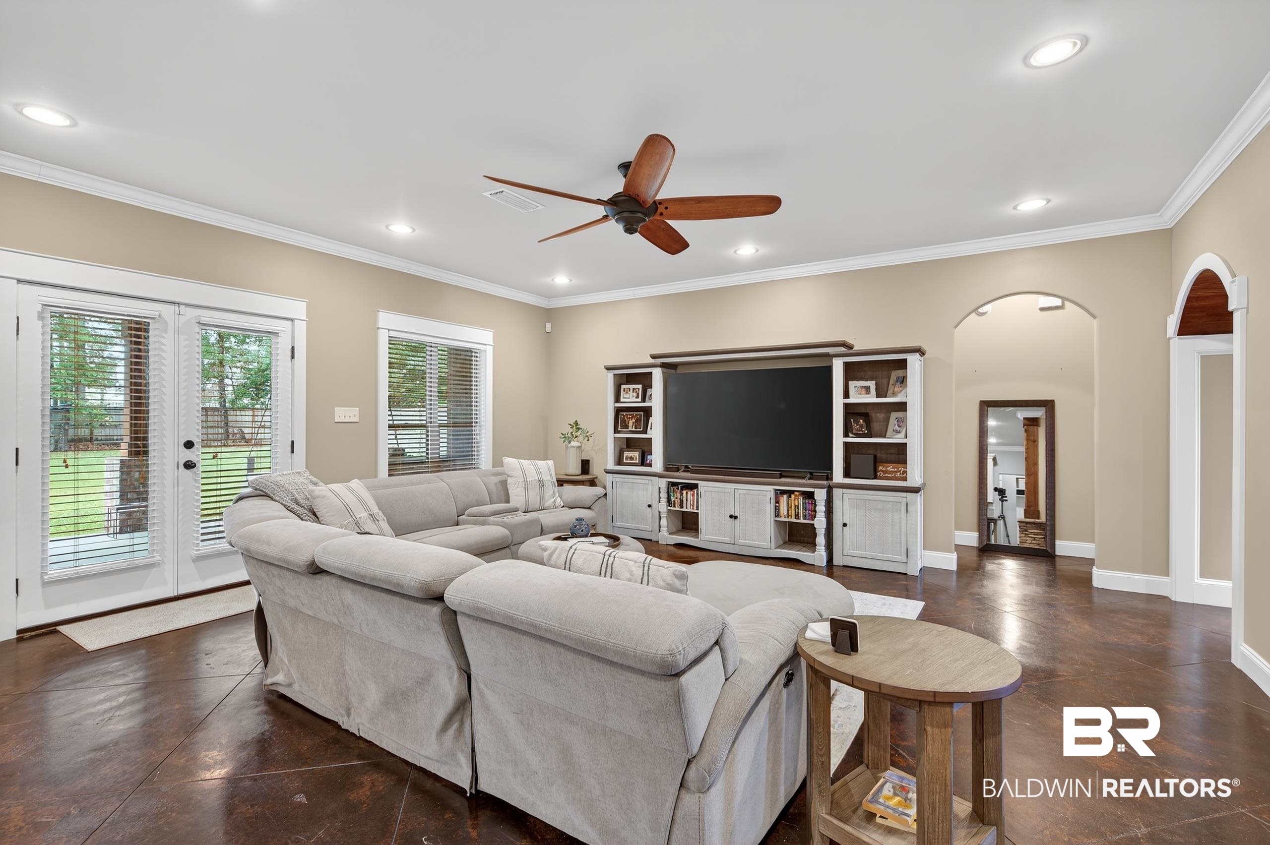 5517 Rabbit Creek Drive Theodore, AL 36582 - Photo 12 of 33 Living area featuring arched walkways, crown molding, finished concrete floors, recessed lighting, and a ceiling fan