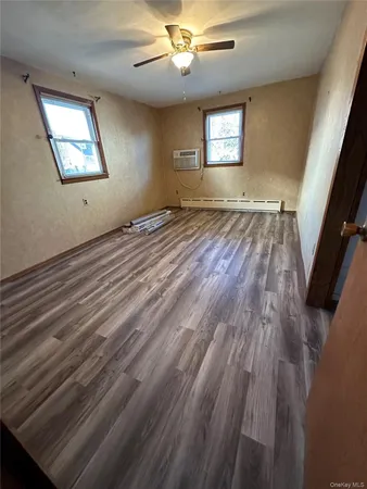 wooden floor in an empty room with a window