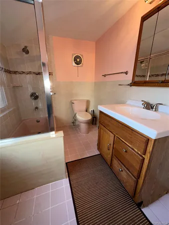 a bathroom with a sink a toilet and mirror