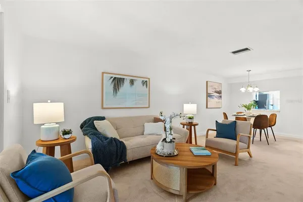a living room with furniture a rug and a lamp