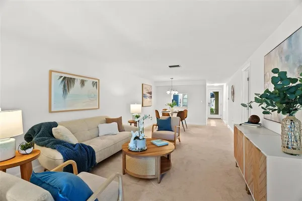 a living room with furniture and flowers