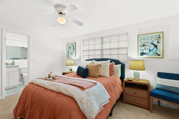 a bedroom with bed and a chandelier