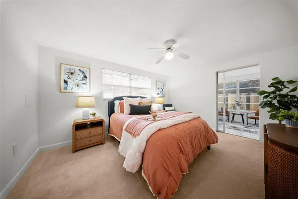 a bed room with bed and a potted plant