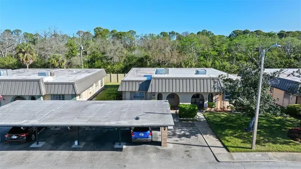 an aerial view of a house with car parked