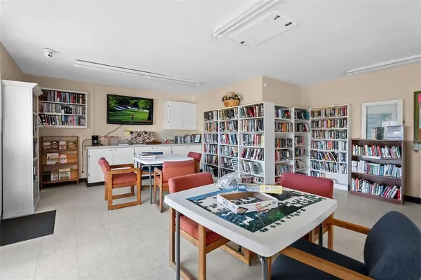 a living room with a floor to ceiling window and a flat screen tv