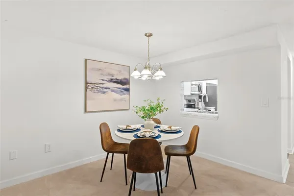 a dining room with furniture and chandelier