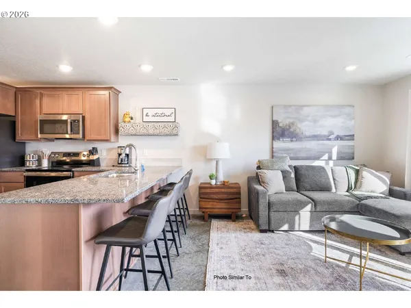 a living room with furniture a flat screen tv and a table