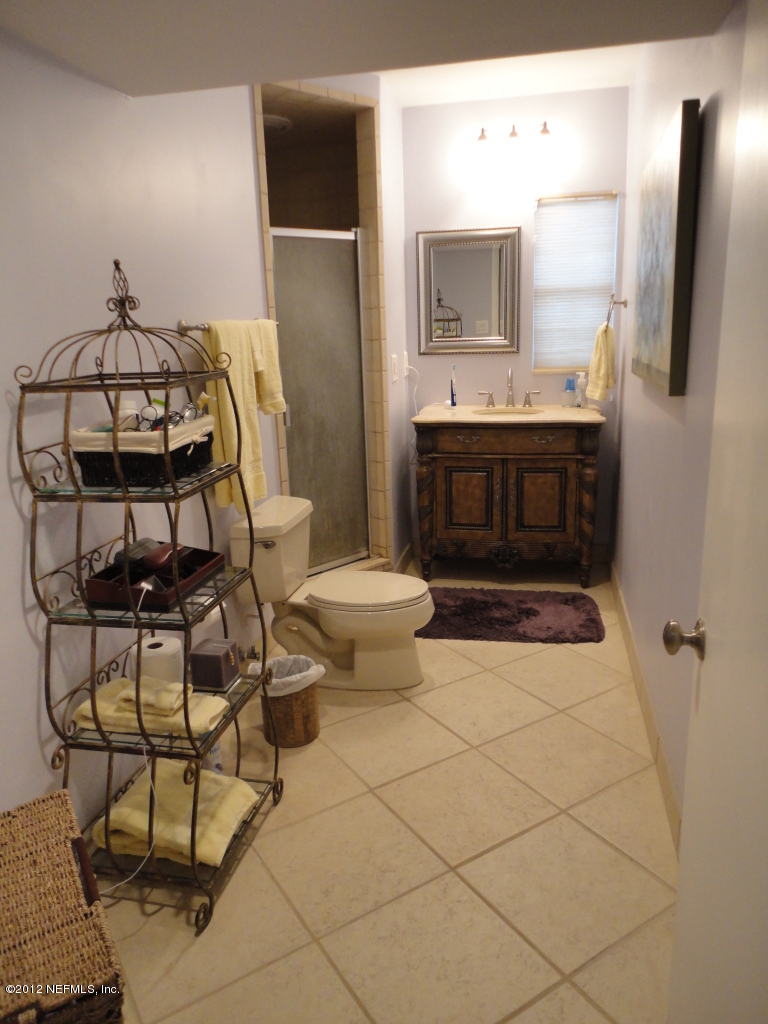 875 Waterman Road North Jacksonville, FL 32207 - Photo 21 of 27 a bathroom with a sink toilet and mirror