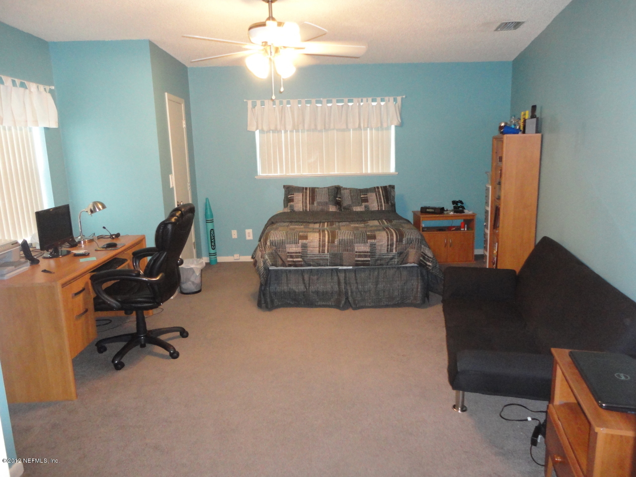 875 Waterman Road North Jacksonville, FL 32207 - Photo 23 of 27 a living room with furniture a flat screen tv and a window